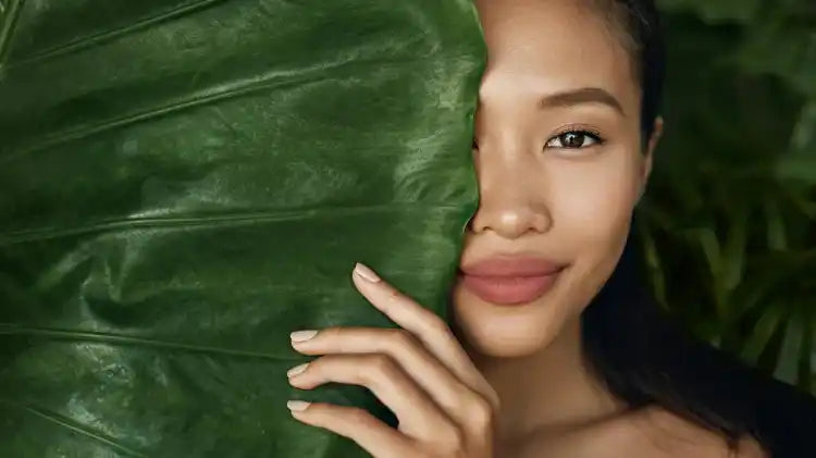 Woman with a large green leaf.